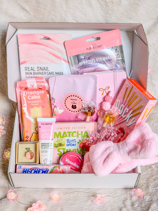 Coffret beauté rose BloomLov ouvert avec masques, bandeau de soin, papeterie, accessoires et gourmandises